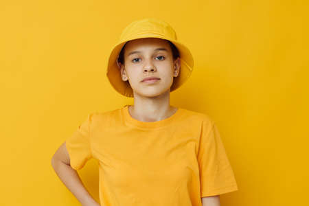 beautiful girl in a yellow t-shirt and Hat emotions summer style isolated backgroundの写真素材