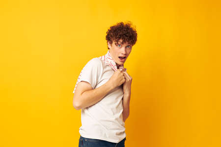 cute red-haired guy putting on a striped t-shirt posing isolated background unaltered