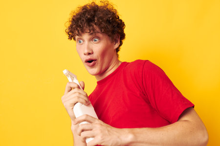 cute red-haired guy detergents home care posing isolated background unalteredの写真素材