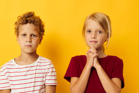 Boy and girl cuddling fashion childhood entertainment isolated backgroundの写真素材