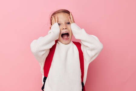 Portrait of happy smiling child girl kids style backpack school isolated backgroundの写真素材