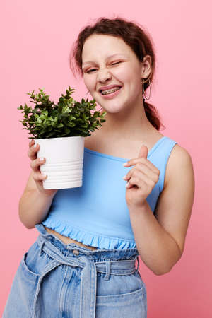 funny girl flower in white pot posing emotion isolated backgrounds unaltered