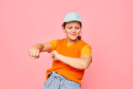beautiful woman grimace earrings cap fashion pink background unaltered