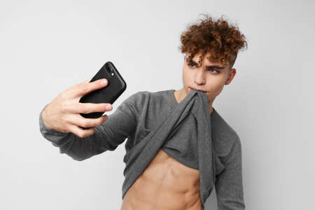 Attractive man technology with phone selfie isolated background