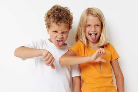 two joyful children casual clothes posing emotions studio isolated background unaltered