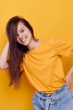 optimistic young woman fashion in yellow t-shirt denim shorts Lifestyle unalteredの写真素材