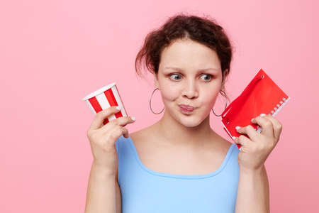 girl with red notepad disposable glass emotions pink background unaltered