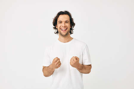 Attractive man in a white T-shirt hand gesture Lifestyle unalteredの写真素材