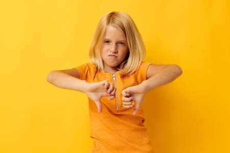kid girl blonde straight hair posing smile fun color background unalteredの写真素材