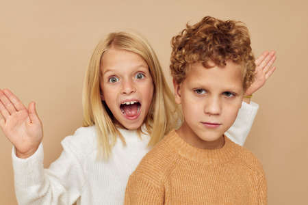 Boy and girl gesticulate with their hands together Lifestyle unalteredの写真素材