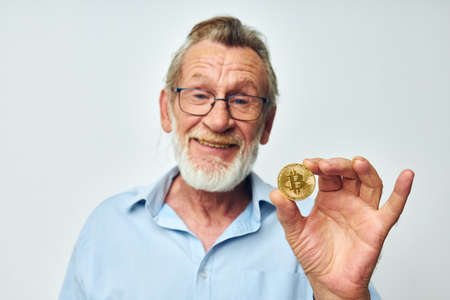 elderly man cryptocurrency bitcoin investment isolated backgroundの写真素材