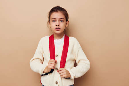 pretty young girl hand gesture red backpack childhood unalteredの写真素材