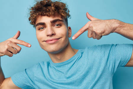 handsome guy in blue t-shirts with a pumped-up body isolated background