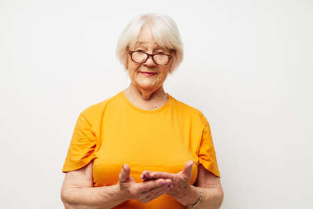 Portrait of an old friendly woman vision problems with glasses close-upの写真素材
