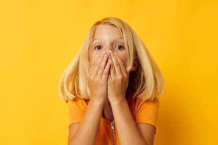 Little girl in a yellow t-shirt smile posing studio childhood lifestyle unalteredの写真素材