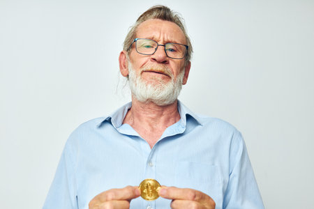 Portrait of happy senior man cryptocurrency bitcoin investment light backgroundの写真素材