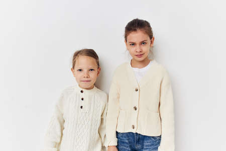 two little girls in sweaters posing friendship fun