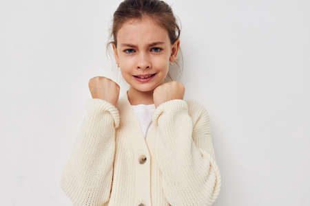 cute girl posing in a white sweater isolated background