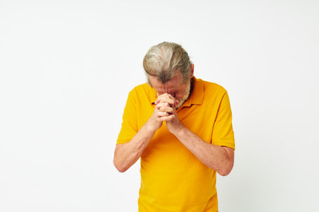 Photo of retired old man with a gray beard emotion gestures hands light backgroundの写真素材