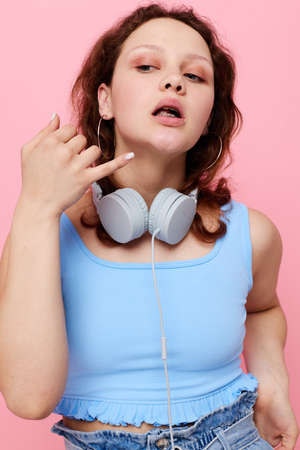 cheerful cute girl wearing headphones fashion entertainment posing unaltered