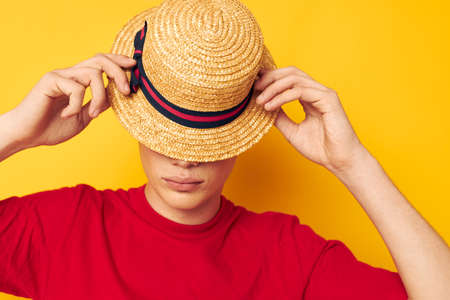 guy with red curly hair casual wear hat posing yellow background unalteredの写真素材
