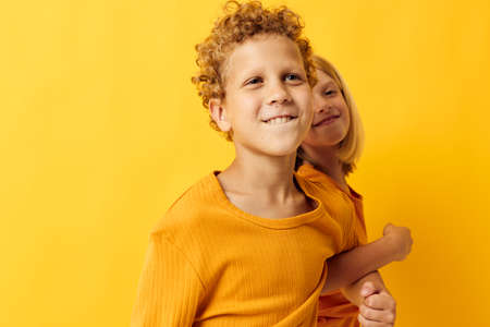 Cute stylish kids casual wear games fun together posing on colored backgroundの写真素材
