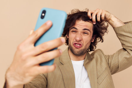 Cheerful man takes a selfie classic style technologies isolated backgroundの写真素材