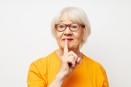 elderly woman health lifestyle eyeglasses treatment light backgroundの写真素材