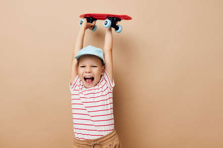 cute girl with a childrens skateboard in hand smile Lifestyle unaltered