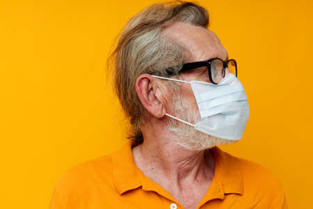 old man medical mask on the face protection close-up cropped view