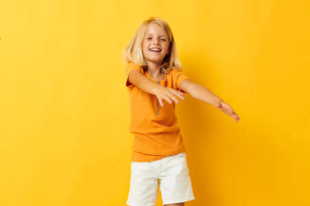 kid girl smile hand gestures posing casual wear fun color background unalteredの写真素材