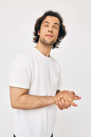 handsome man in a white T-shirt hand gesture isolated background