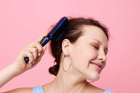 teenager girl removes hair on a comb dissatisfaction close-up unaltered