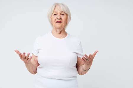 emotional elderly woman smile hand gesture isolated background. High quality photoの写真素材