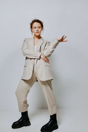 pretty woman Clothes fitting elegant style suit fashion studio light background unalteredの写真素材