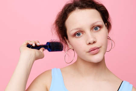 beautiful woman removes hair on a comb dissatisfaction isolated background unalteredの写真素材