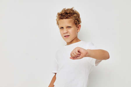 Photo of young boy in a white t-shirt posing fun isolated backgroundの写真素材