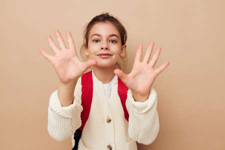 little girl schoolgirl with red backpack posing childhood unalteredの写真素材