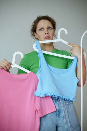 cheerful woman trying on clothes wardrobe Youth style light background unalteredの写真素材