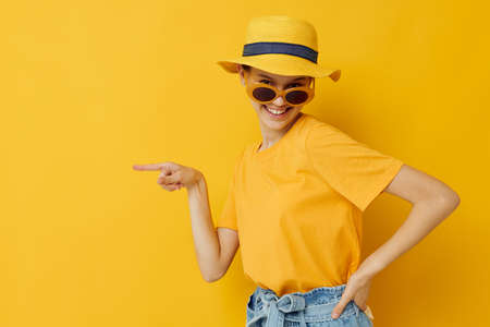 beautiful girl in a yellow hat Youth style casual wear in sunglasses Lifestyle unalteredの写真素材
