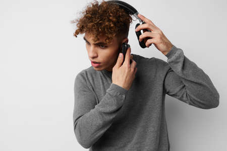 handsome guy headphone music technology with phone isolated backgroundの写真素材