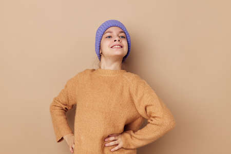 little girl in caps and sweaters posing