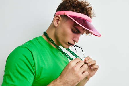 handsome young man green t-shirt decoration fashion glasses Lifestyle unalteredの写真素材