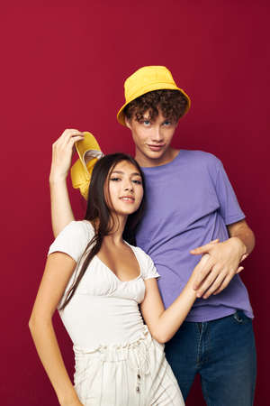 Man and woman in colorful t-shirts stylish clothes hats isolated backgroundの写真素材