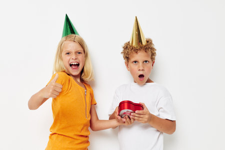 Cheerful boy with girl with hats gift birthday holidayの写真素材