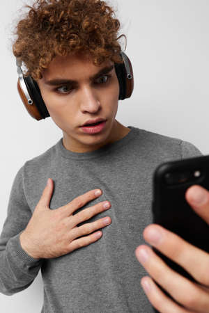 stylish guy looking at the phone headphones fashion Lifestyle unalteredの写真素材