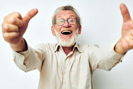 Photo of retired old man wears glasses in shirts light backgroundの写真素材