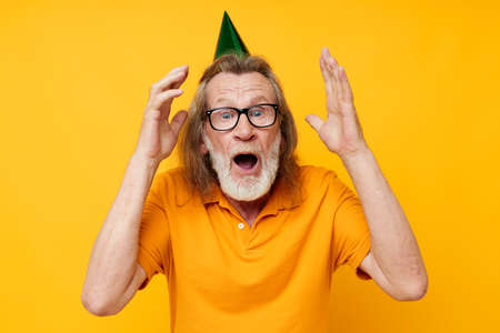old man wearing glasses green cap on his head holiday emotions isolated background