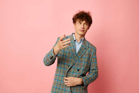 guy with red curly hair in a suit business look posing emotions Lifestyle unalteredの写真素材