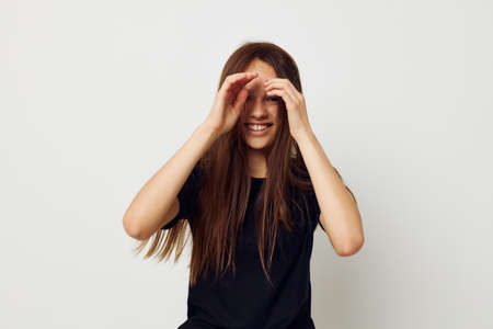young beautiful woman in a black t-shirt hand gesture fun Lifestyle unalteredの写真素材
